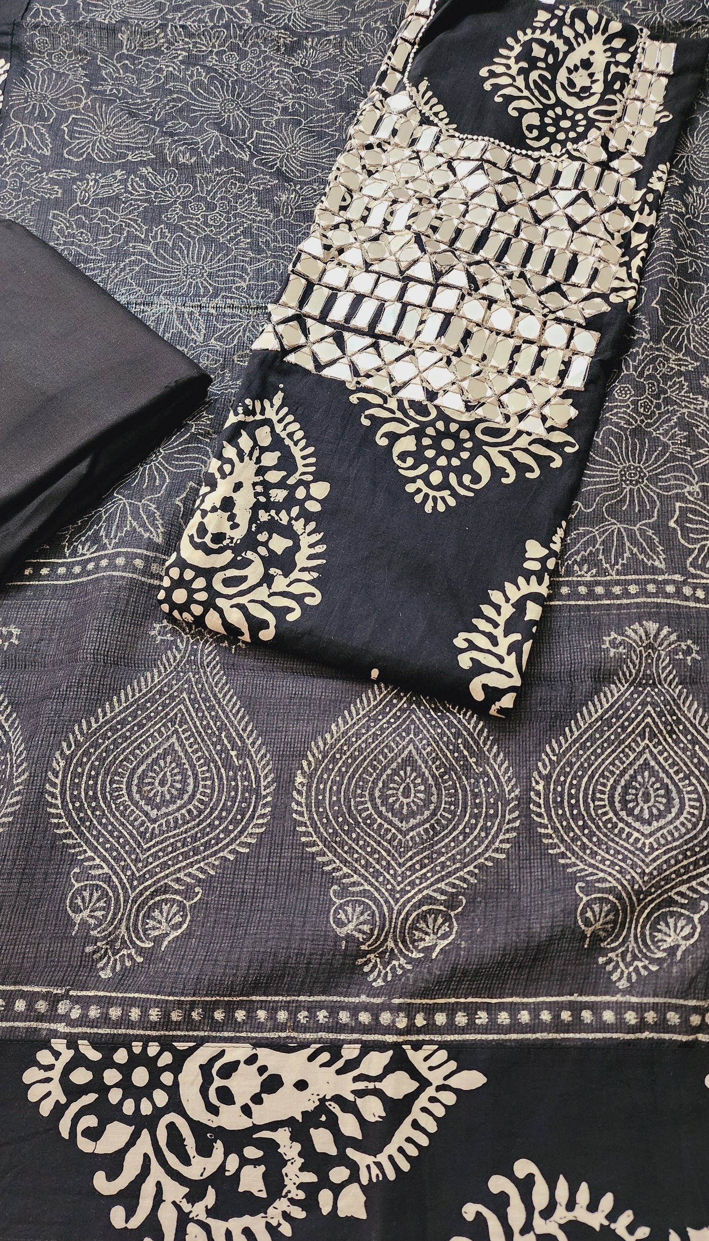 Close-up of a black fabric with white intricate patterns