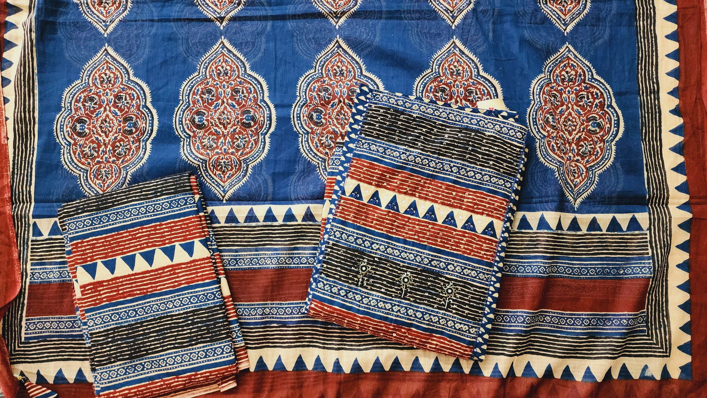 Traditional patterned fabric with blue, red, and black colors on a red background